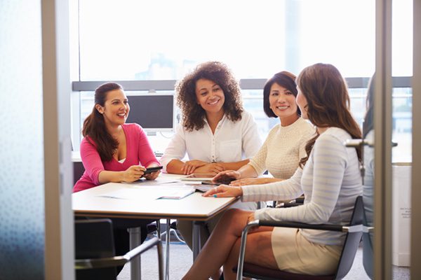 Four women having a meeting in an office
